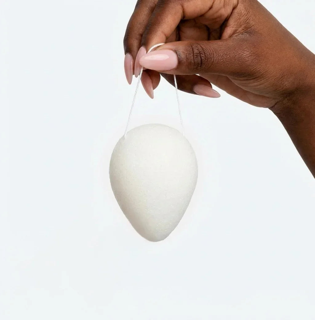 Seele & Bloom konjac sponge for gentle facial cleansing, soft natural fiber exfoliator, shown in close-up.