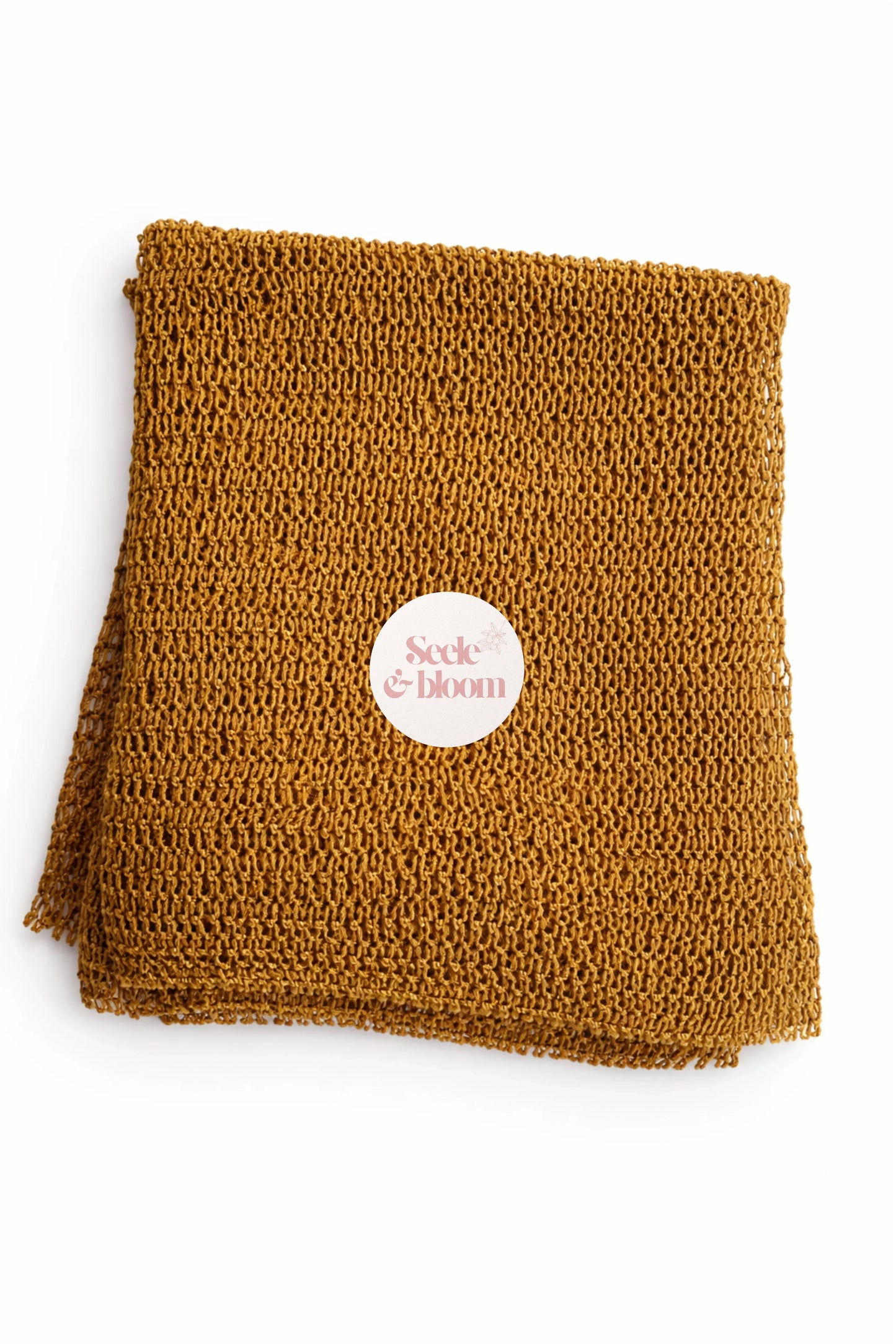 African net sponge by Seele & Bloom, a natural exfoliating loofah with a textured, netted surface for gentle skin cleansing.