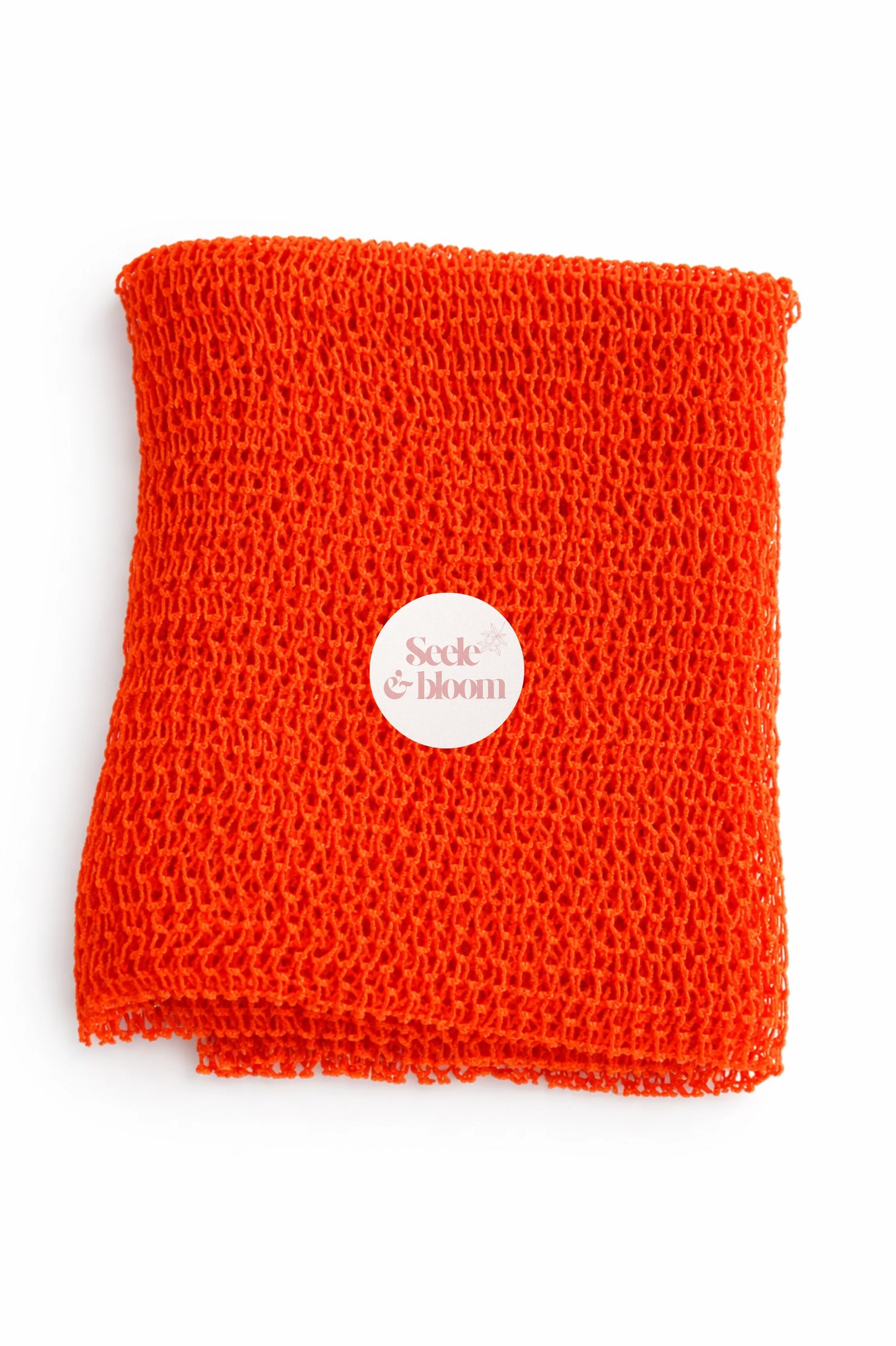 African net sponge by Seele & Bloom, showing its textured, open-net design ideal for exfoliating and skincare.